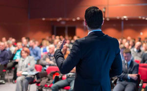 man speaking before an audience